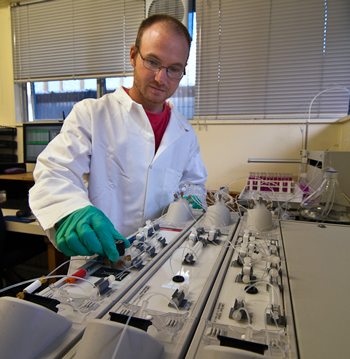 A male scientist operating an instrument.